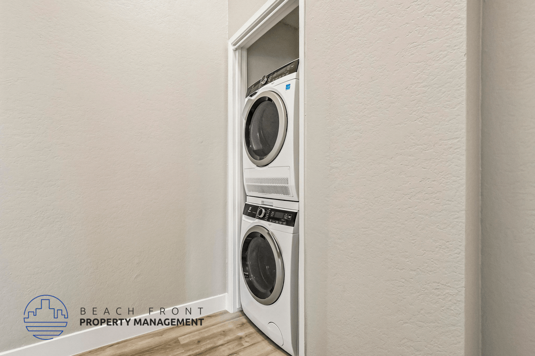 A white washing machine is built into a wall.